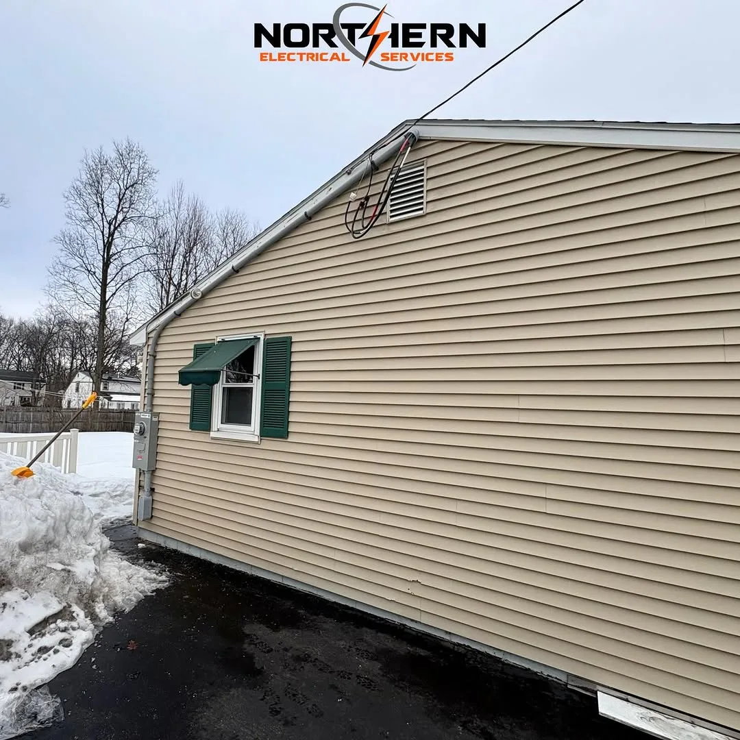Exterior service drop at gable end of house